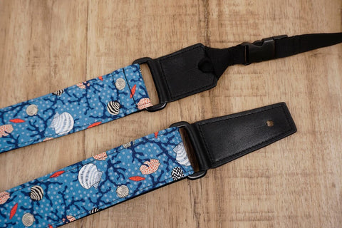 shell on light blue ukulele shoulder strap with leather ends-4
